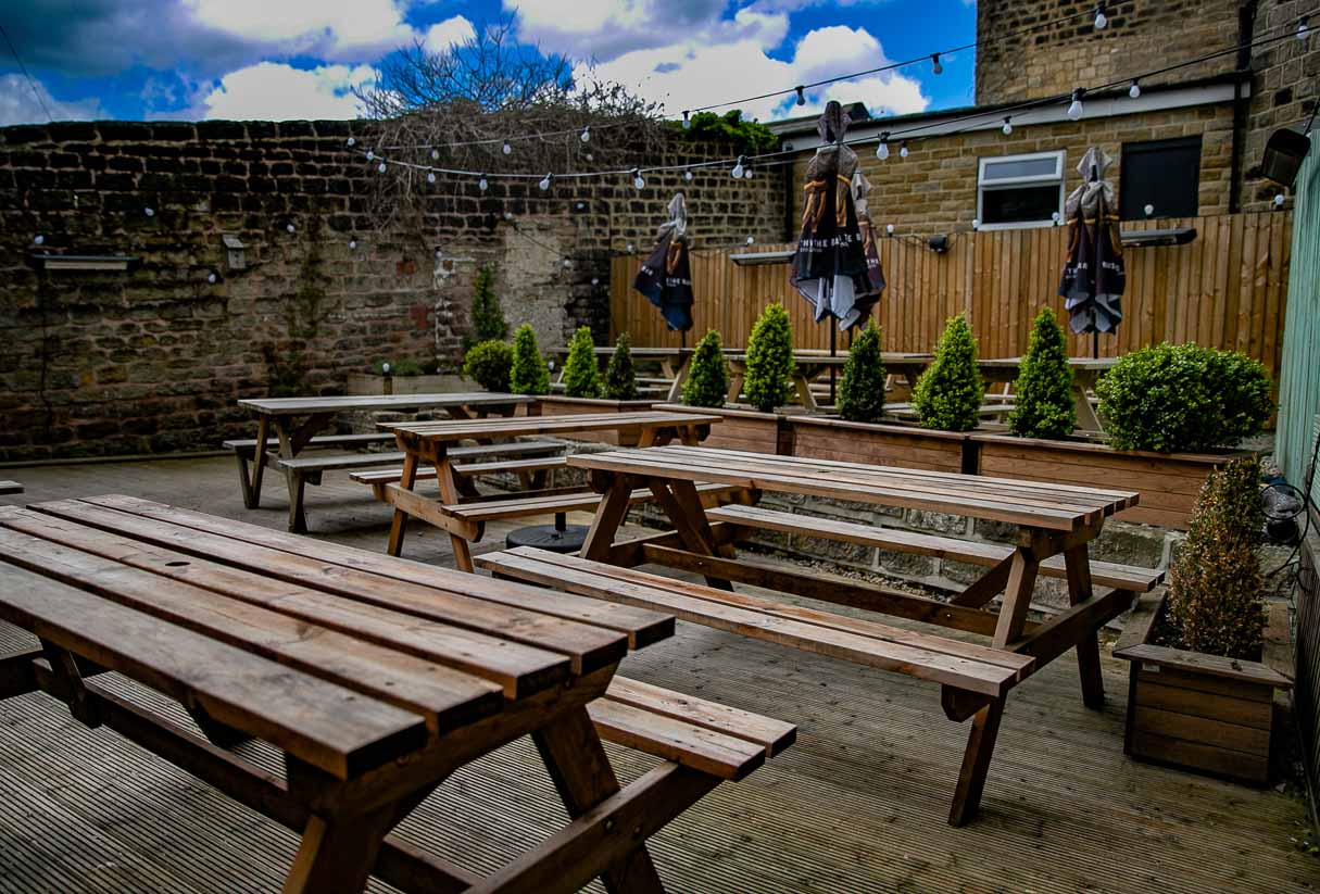 The beer garden private hire event space with heaters and festoon lighting in Horsforth
