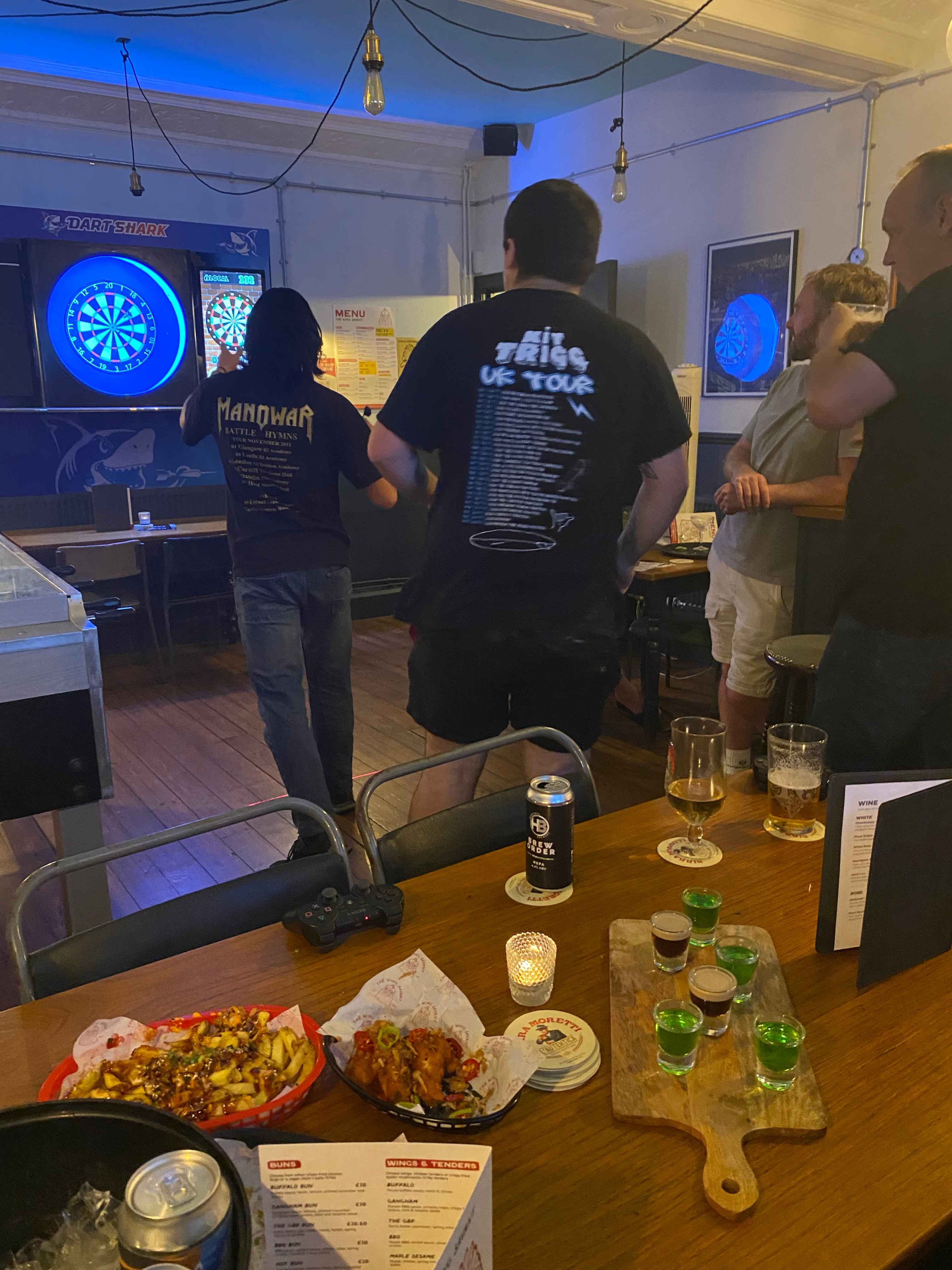 Guests playing darts in The Games Room