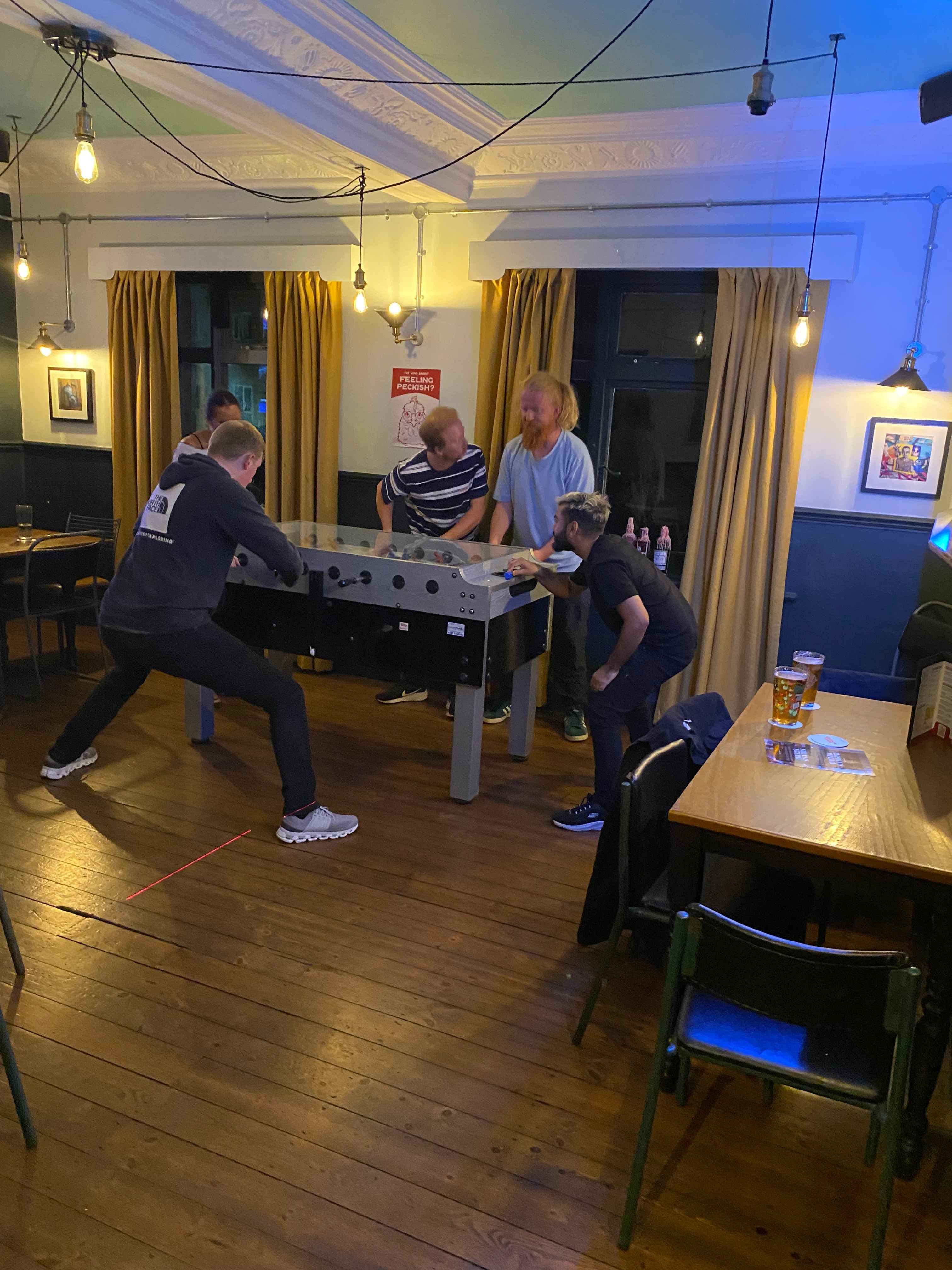 Guests playing foosball in The Games Room
