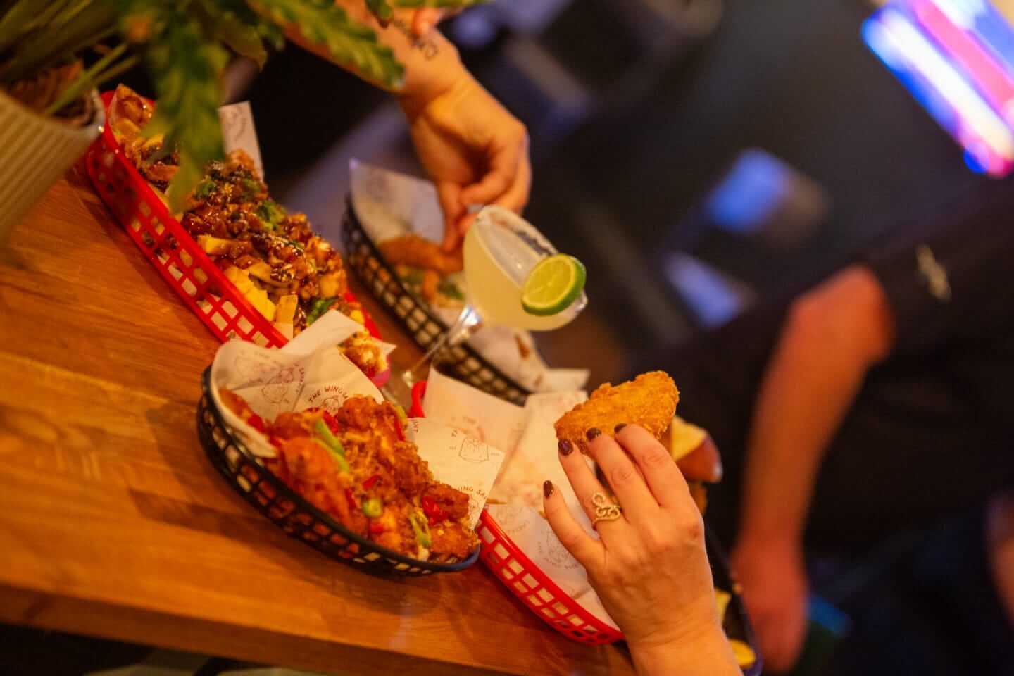 Guests enjoying food and drinks in the Old King’s Arms Games Room